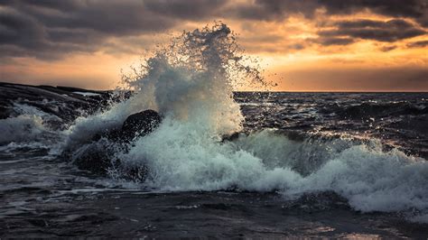 Sunset Ocean Waves Crashing Over Rocky Shore – HD Nature Wallpaper