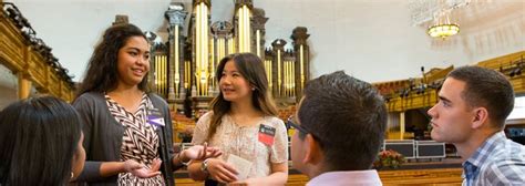 a group of people standing around each other in front of a church organ ...