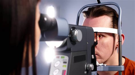 A retinal exam was performed on a man using an optical coherence tomography. Doctor testing for ...