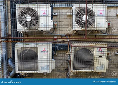 Shot of Four Air Conditioning Condenser Units on the Side of a Building ...