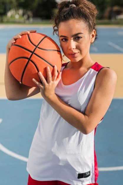 Front view of girl holding basketball ball | Free Photo