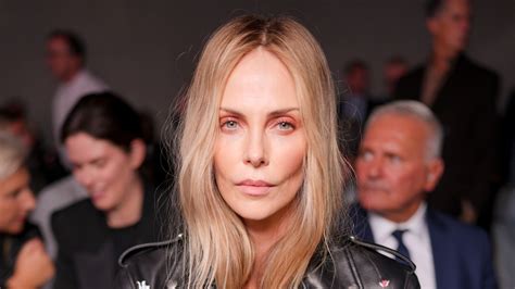 Charlize Theron opts for nothing under her leather biker jacket for ...