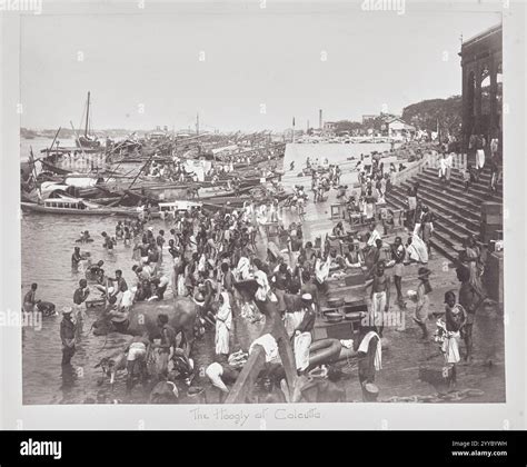 The Hooghly River at Calcutta / Kolkota. Large crowd bathing in the river's water. Archive ...