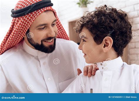 Happy Arab Father Holds Small Son by Shoulder. Stock Image - Image of ...