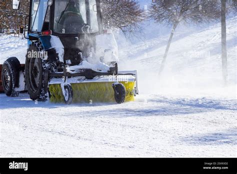 Snow plough truck clears snow from the road after a snowfall. Part of ...