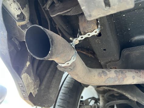 Muffler hanger broke off. So I fixed it the cheapest way I knew how. : r/redneckengineering