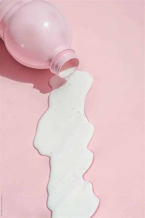 Spilled Milk From Pink Bottle On Pink Background