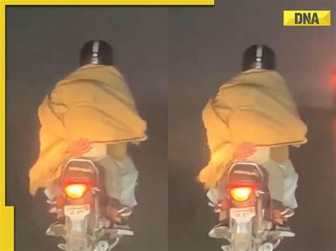 Father tenderly shields child from biting cold with shawl while riding ...