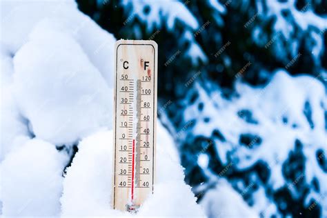 Premium Photo | Thermometer on snow with low temperatures in celsius or ...