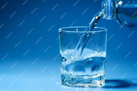 Premium Photo | Studio shot clean drinking water poured into glass and ...