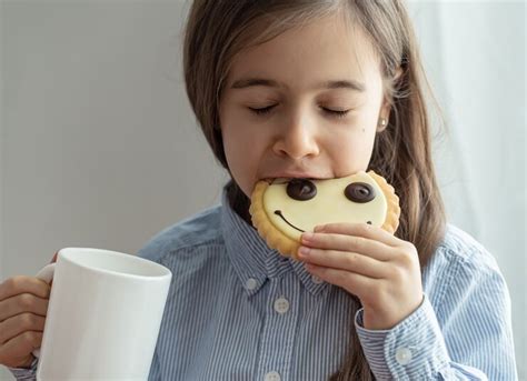 An elementary school girl is having breakfast with milk and funny ...