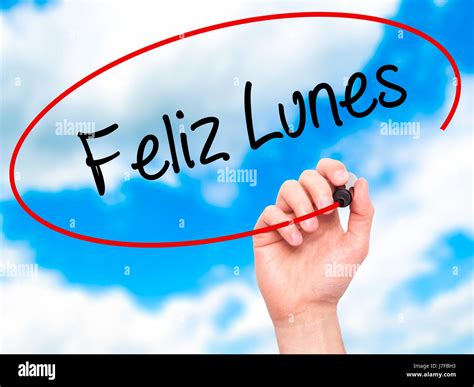 Man Hand writing Feliz Lunes (Happy Monday In Spanish) with black ...