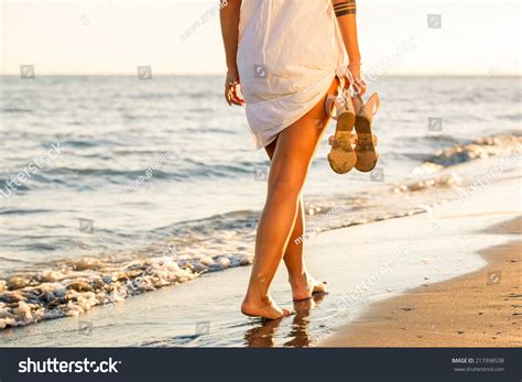 Woman Walking Alone On Beach
