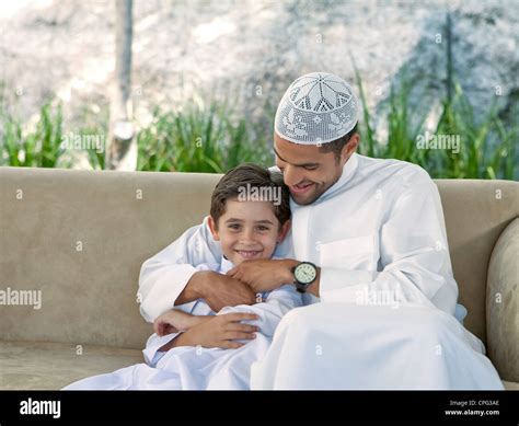 Arab father and son playing at the sofa Stock Photo - Alamy