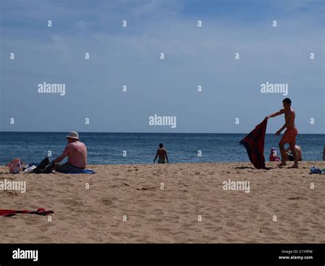 people enjoying sun on the beach Stock Photo - Alamy