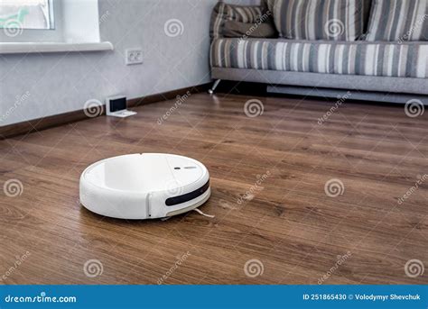 Robotic Vacuum Cleaner on Laminate Wood Floor. Smart Cleaning ...