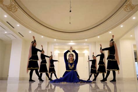 Boshra, a women's dance coach, practices with members of her ...