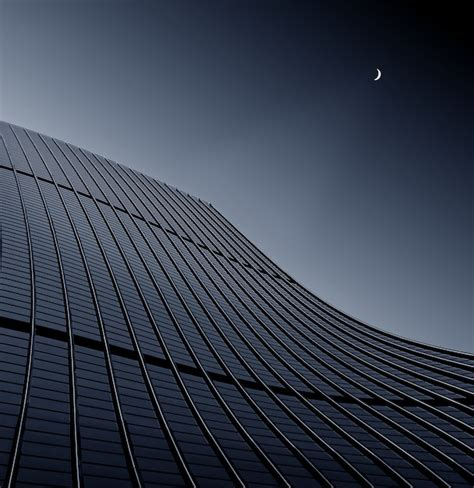 Low angle shot of a modern business building touching the clear sky ...