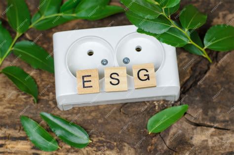 Premium Photo | Esg abbreviation on wooden cubes against the background of a white rosette the ...