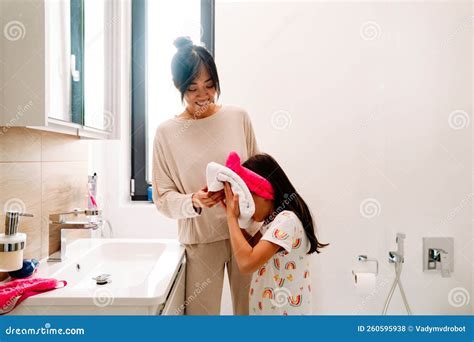 Asian Girl Wearing Headband Washing Up with Mother in Bathroom Stock ...