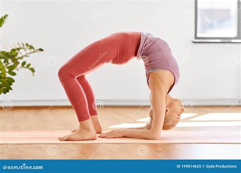 Young Woman Doing Bridge Pose at Yoga Studio Stock Image - Image of exercising, gymyoga: 199014625