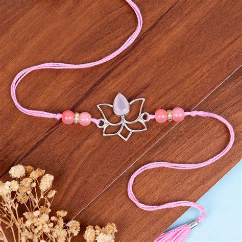 Send Rose Quartz Lotus Rakhi with Roli Chawal Online | Rakhibazaar.com