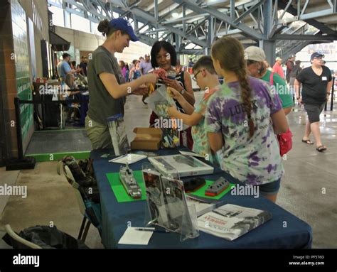 Visitors to the Hampton Roads Naval Museum's booth learn about the ...