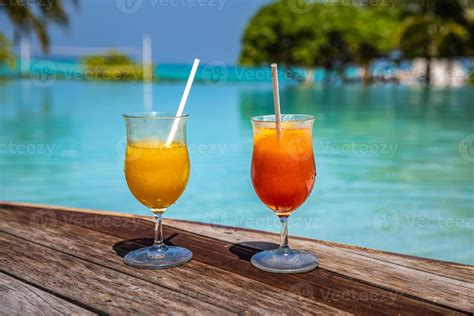 Two cocktails on luxury tropical beach resort. Couple vacation, travel ...