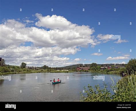 A canoe floats in the Deschutes River in the Old Mill Shopping District ...