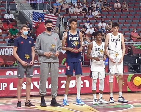 A 7’4 Victor Wembanyama standing next to a 7’2 Chet Holmgren and 7’3 ...