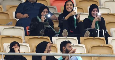 Saudi Arabia women react after entering a football stadium for first time