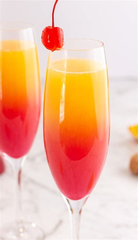 sunset mocktail in a champagne glass with red at the bottom gradually ...