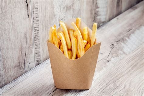 Close up view on potatoes french fries in carton package box isolated ...