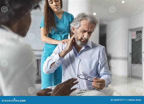 Patient Complains To the Doctor about His Neck Pain and Other Symptoms. Young Female Doctor and ...