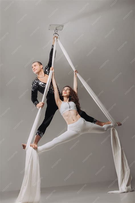 Premium Photo | Two aerial gymnasts performing silk acrobatics