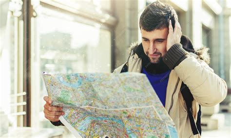 Premium Photo | Lost tourist looking at city map on