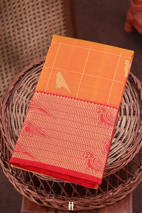 Kanchipuram Silk Saree In Orange Along Checks With Buttas