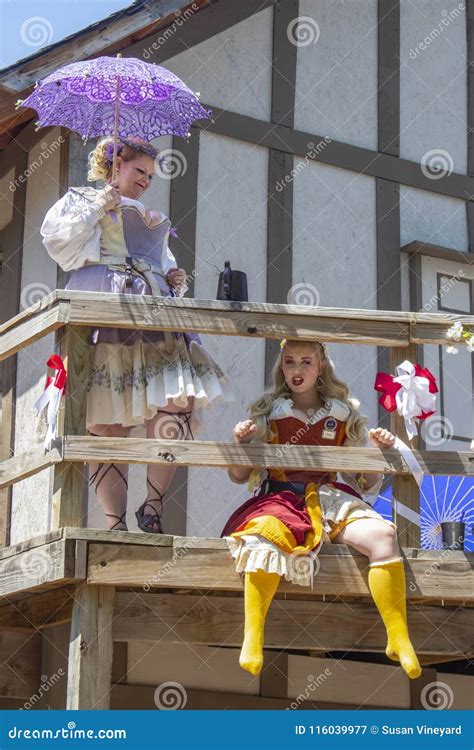 Women in Costume Acting Like a Madam and a Prostitute on Balcony ...