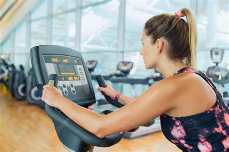 Woman riding exercise bike at gym - Stock Image - F015/5756 - Science ...