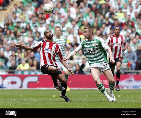 Yeovil Town's Paddy Madden (right) and Brentford's Shaleum Logan (left ...