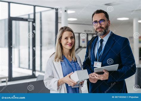 Pharmaceutical Sales Representative Talking with Doctor in Medical Building. Ambitious Male ...