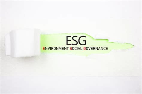 Premium Photo | Esg environmental social governance text abbreviation on a torn paper esg concept