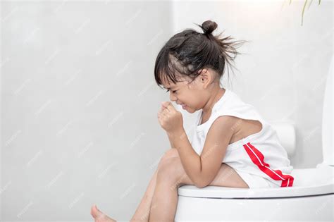 Premium Photo | The little girl is sitting on the toilet suffering from constipation or hemorrhoid