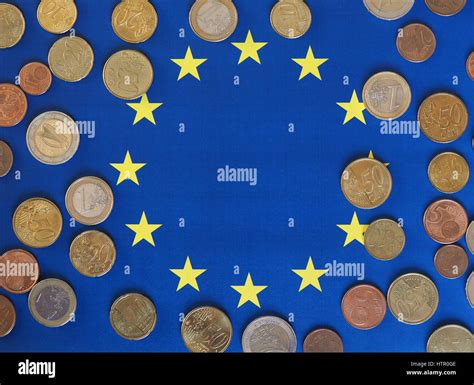 Euro coins (EUR), currency of European Union over flag of Europe Stock Photo - Alamy