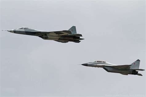 Russian T-50 PAK-FA fifth generation fighter flies alongside the MiG ...