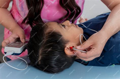 Premium Photo | Closeup of the ear of a child who is undergoing a ...