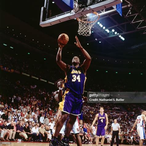 Shaquille O'Neal of the Los Angeles Lakers goes for a layup over Ben ...