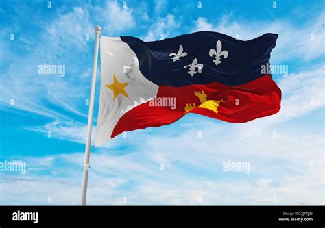 flag of Acadiana, France at cloudy sky background on sunset, panoramic ...