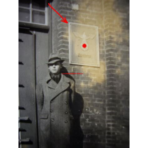 Man next to district administrator sign with eagle and swastika ...