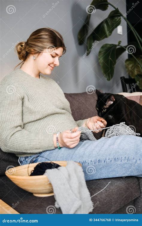 Pregnant Woman Knitting with Black Cat beside, Preparing Handmade Baby ...